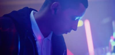 a man in a suit and tie looking at his cell phone