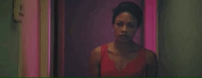 a woman in a red dress standing in a hallway