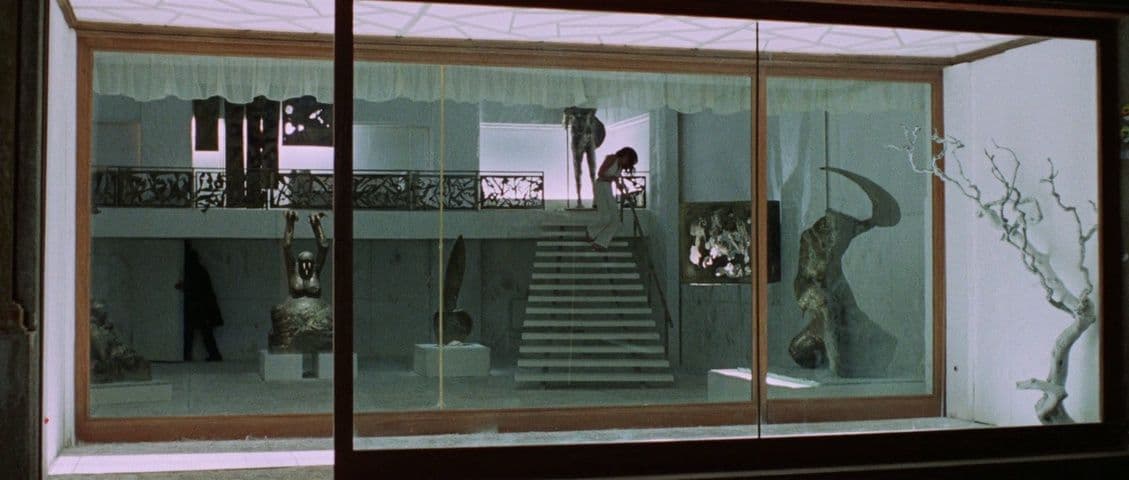 a room filled with statues and a staircase