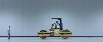a man standing in front of a fork lift