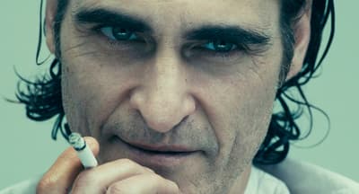a close up of a person smoking a cigarette