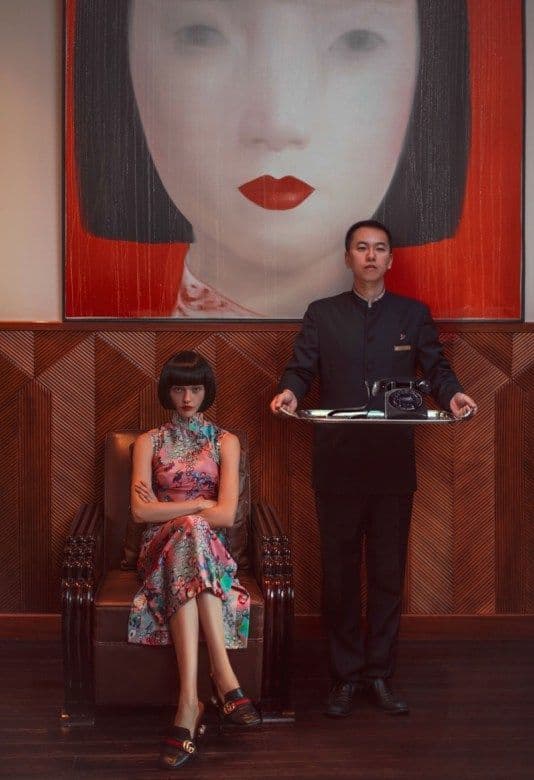 a man standing next to a woman holding a tray