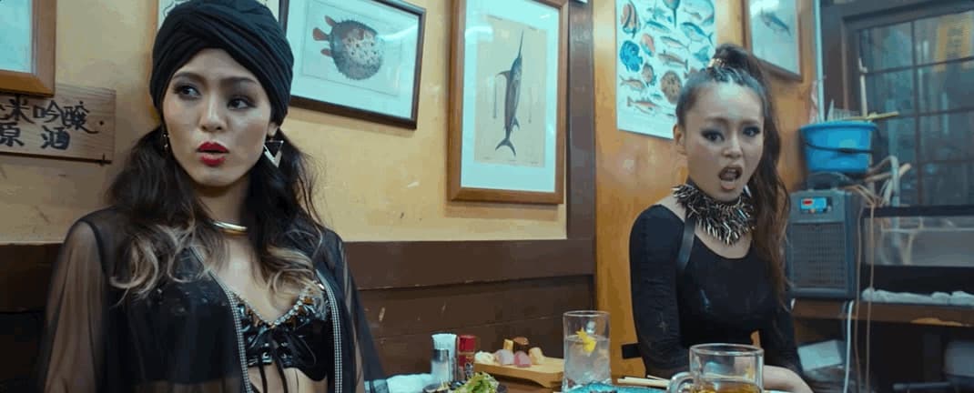 two women sitting at a table in a restaurant