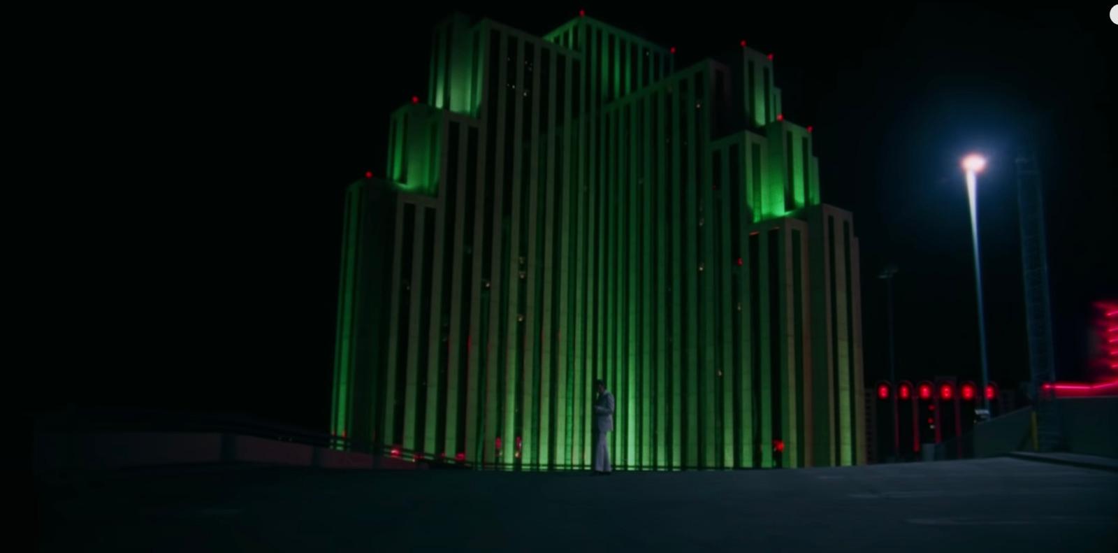 a tall building lit up at night in the dark