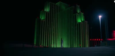 a tall building lit up at night in the dark