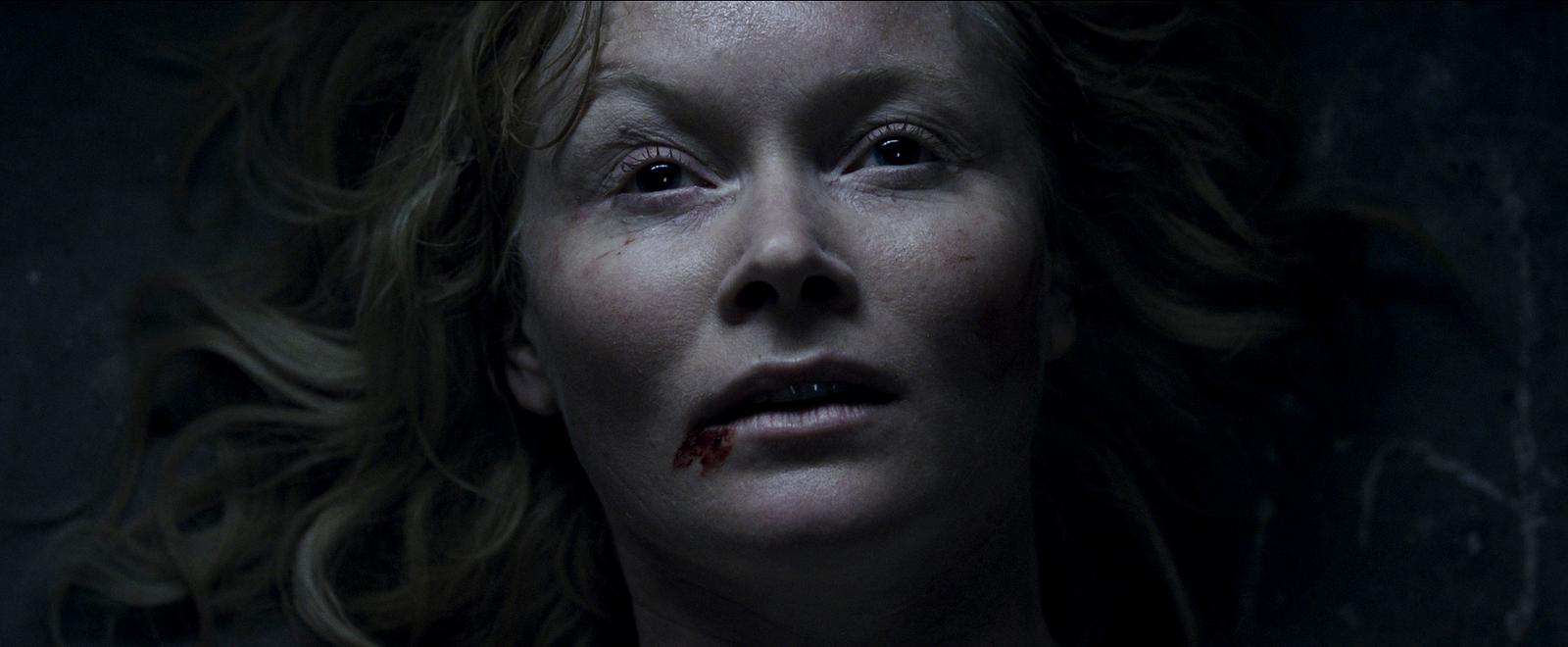 a close up of a person with blood on her face