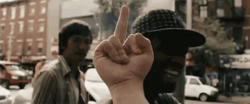 a man is holding up a finger in front of a group of people