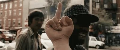 a man is holding up a finger in front of a group of people