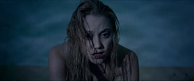 a woman with a knife in her mouth