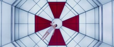 a woman in a white dress is standing in a red and white room