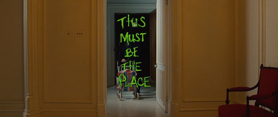 a woman standing in a doorway with a green sign on the door