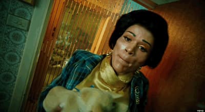 a woman holding a cat in a room