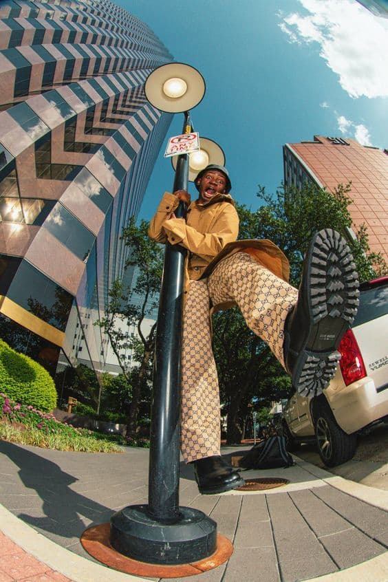 a woman standing on top of a lamp post