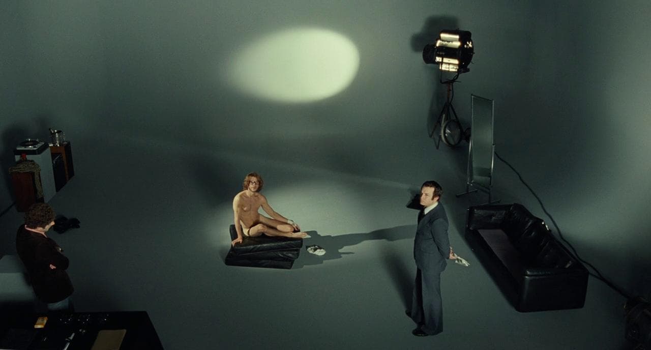 a man sitting on a chair in front of a woman