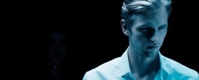a man in a white shirt and a black background