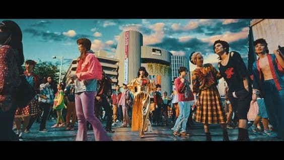 a group of people standing around each other