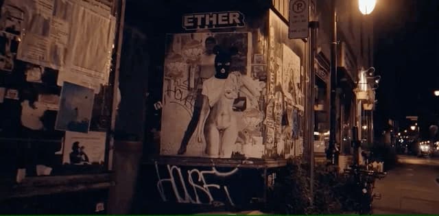a street corner with a poster on the side of it