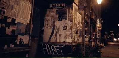 a street corner with a poster on the side of it