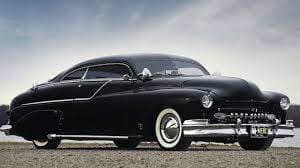 a classic car parked on the side of the road