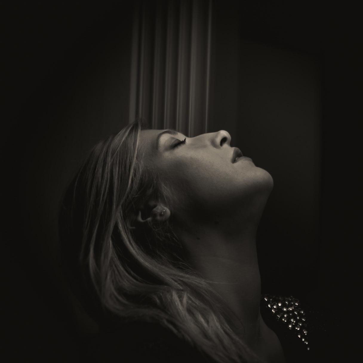 a black and white photo of a woman looking up