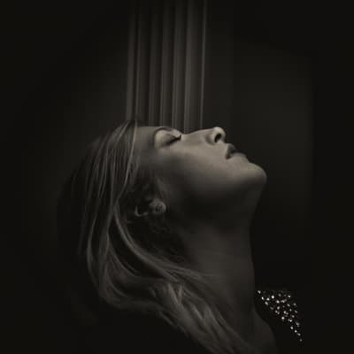 a black and white photo of a woman looking up