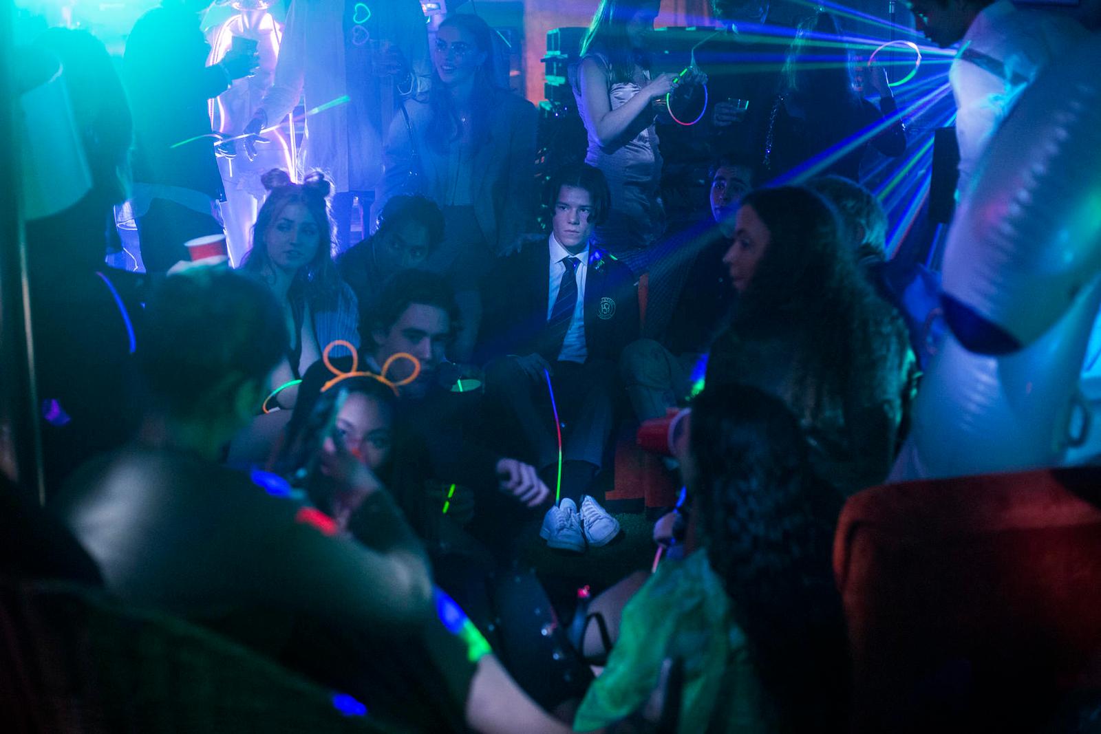 a group of people sitting in a room at a party