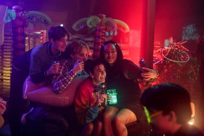 a group of people sitting around each other in a room