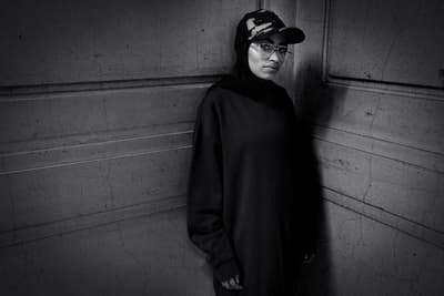 a black and white photo of a woman wearing a hat