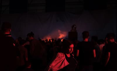 a group of people standing around in a dark room