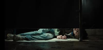 a person laying on the ground in the dark