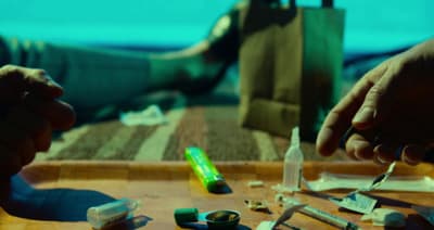 a person sitting at a table with a lot of items on it
