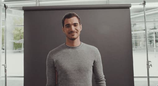 a man standing in front of a black backdrop