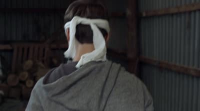 a woman with a white mask covering her eyes