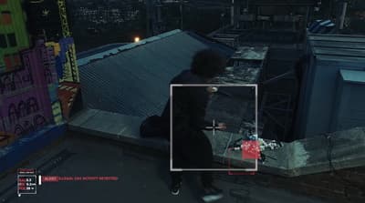 a person standing on top of a roof next to a building