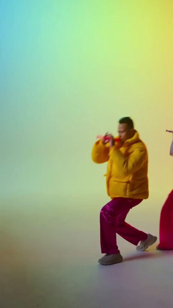 a man in a yellow jacket standing next to a woman in a red dress