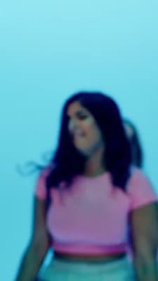 a blurry photo of a woman in a pink shirt