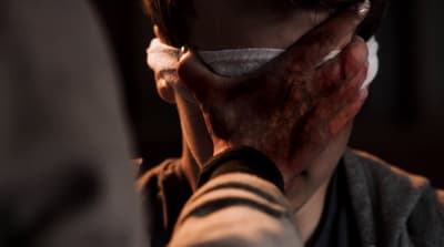 a woman with a bandaged face covering her face