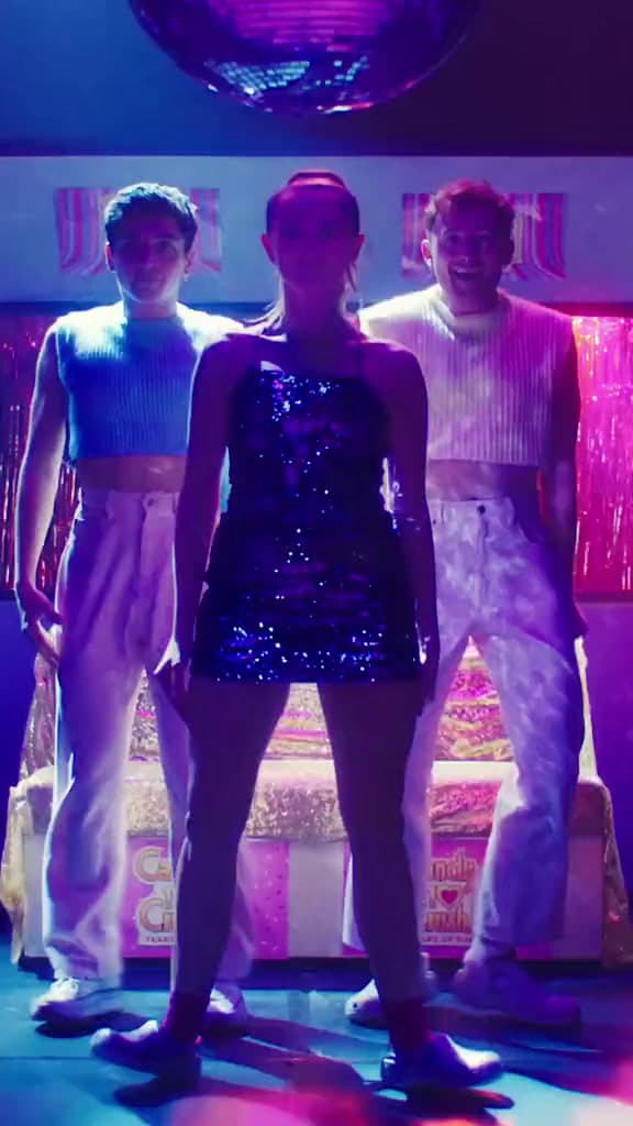a group of people standing in front of a disco ball