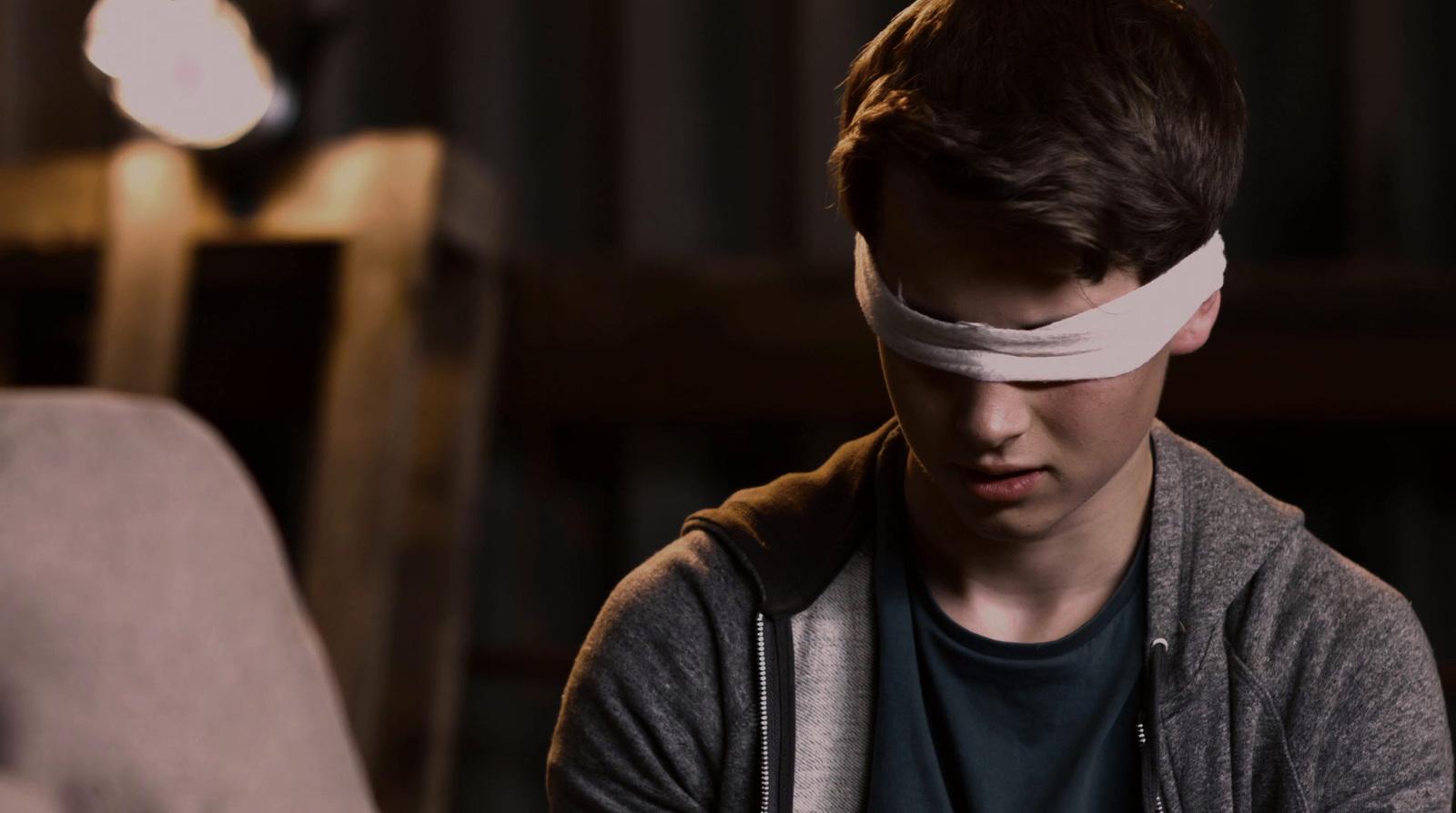 a young man with a blindfold around his head
