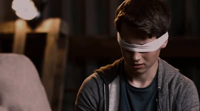 a young man with a blindfold around his head