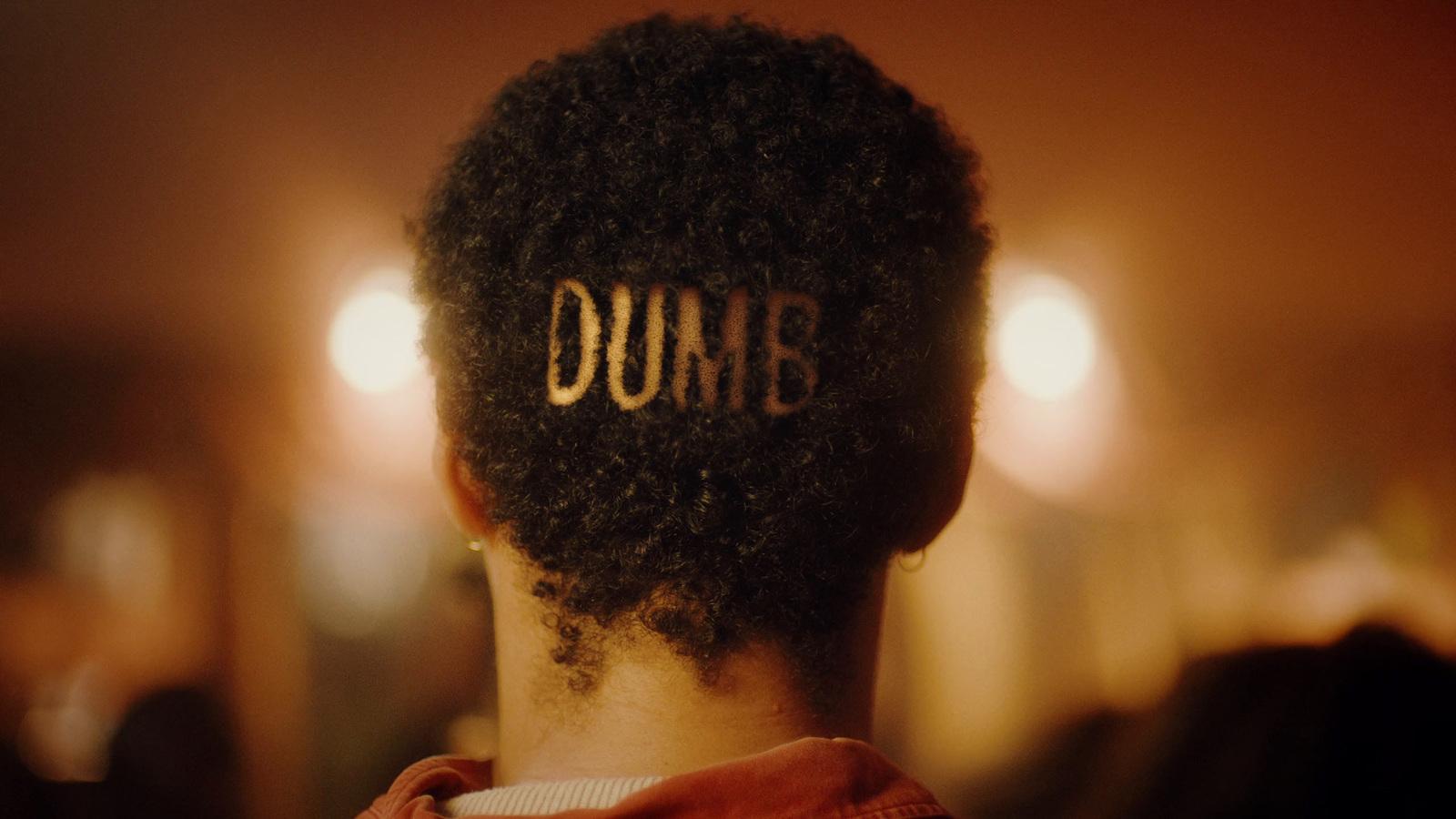 a woman with the word dumb written on her back