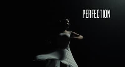a woman in a white dress standing in the dark