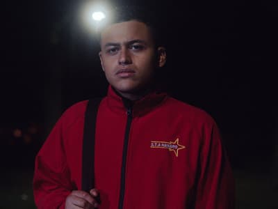 a man standing in the dark with a light on his head