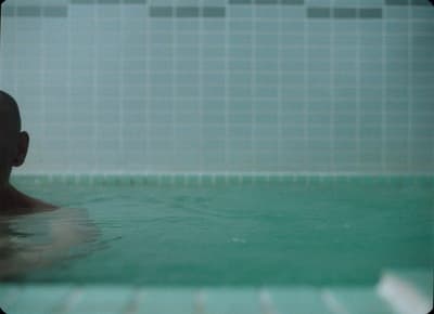 a man swimming in a pool of water