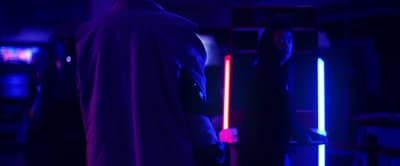 a man and a woman standing in a dark room