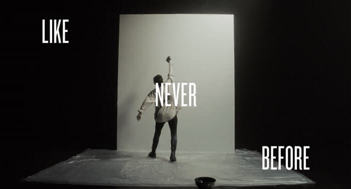 a black and white photo of a person standing on a stage
