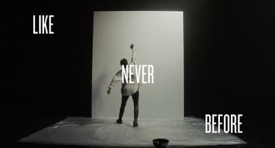 a black and white photo of a person standing on a stage