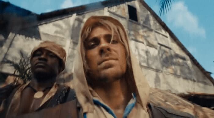 two men standing next to each other in front of a building