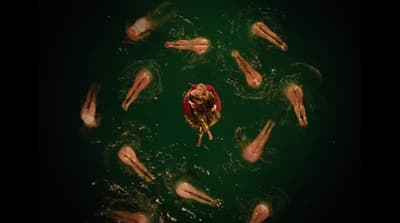 a group of people floating in a body of water