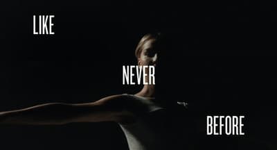 a woman with her arm stretched out in the dark